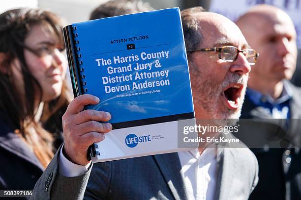 Rev. Patrick Mahoney holds a petition while speaking to the media before David Daleiden, a defendant in a Planned Parenthood video speaks at the...