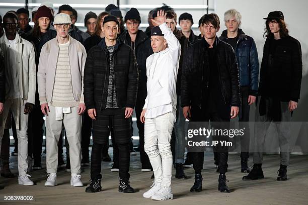 Designer John Elliott waves to the audience at the conclusion of his John Elliott + CO show during NYFW Men's F/W 2016 at Skylight at Clarkson Sq on...