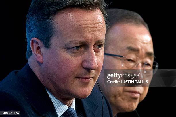 British Prime Minister David Cameron and UN Secretary-General Ban Ki-moon sit on stage during a press conference at the QEII centre in central London...