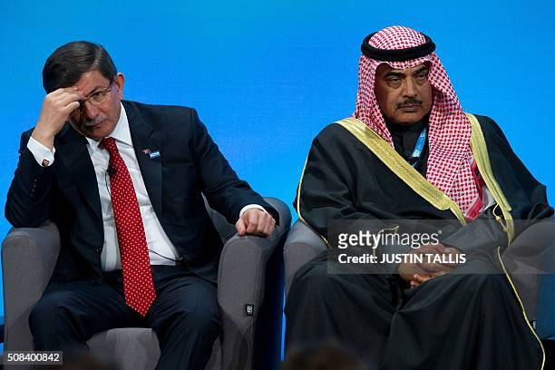 Turkish Prime Minister Ahmet Davutoglu and Kuwaiti Foreign Minister Sabah al-Khalid al-Sabah sit and listen to speakers during a press conference at...