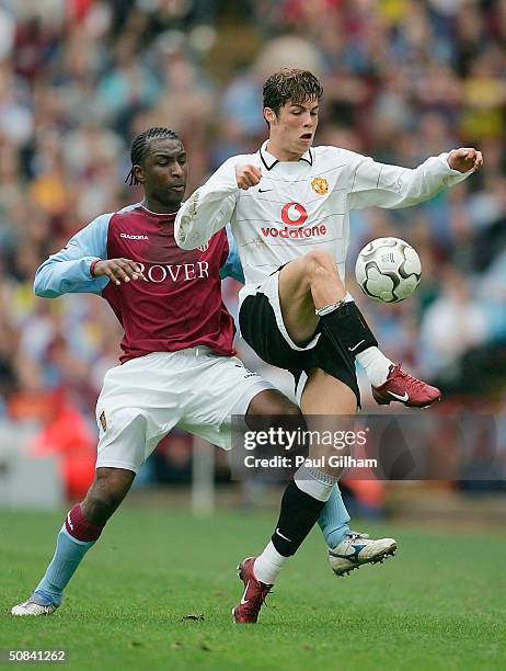 Cristiano Ronaldo of Manchester United battles for the ball with Jlloyd Samuel of Aston Villa during the FA Barclaycard Premiership match between...