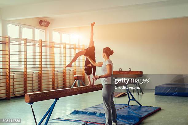 girl practicing gymnastics - balance beam stock pictures, royalty-free photos & images