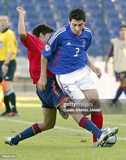 French defender Thomas Mangani is tackled by Spanish midfielder Carlos Carmona Bonet during the Under 17 European Championship final football match,...