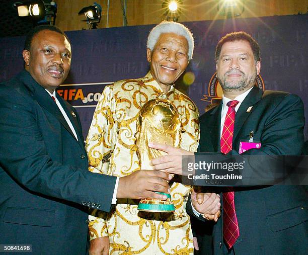 Bid Chairman Irvin Khoza , Former South African President Nelson Mandela and Bid CEO Danny Jordaan pose with the world cup trophy during the FIFA...