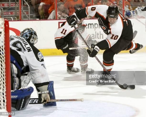 John LeClair of the Philadelphia Flyers takes a shot against goalie Nikolai Khabibulin of the Tampa Bay Lightning in Game four of the 2004 NHL...
