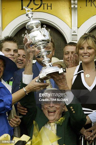 Owner Roy Chapman holds the Woodlawn Vase after his horse Smarty Jones won the 129th running of the Preakness Stakes at Pimlico Race Course in 15 May...