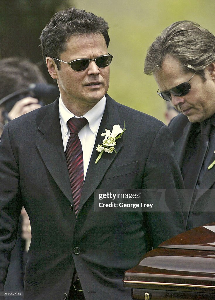 Donny Osmond and Jimmy Osmond help carry the casket of their mother