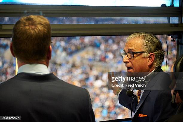 Playoffs: Rear view of Fox Sports rules expert and former NFL vice president of officiating Mike Pereira speaking with announcer Troy Aikman during...