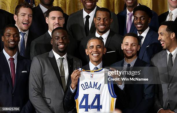 President Barack Obama holds a Golden State Warriors basketball jersey during an event with the team in the East Room on February 4, 2016 in...