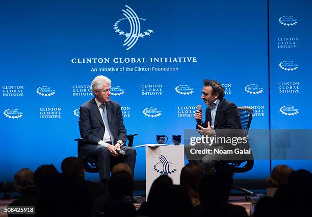 Former President Bill Clinton speaks with founder of Tent Foundation Hamdi Ulukaya at The Clinton Global Initiative Winter Meeting at Sheraton New...