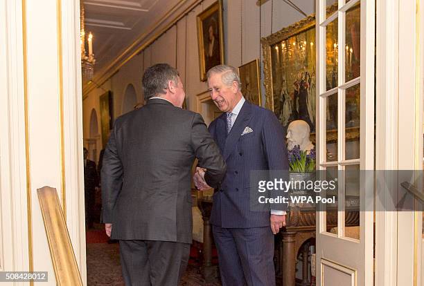 Prince Charles, Prince of Wales greets King Abdullah II of Jordan at Clarence House on February 4, 2016 in London, United Kingdom. The Prince of...
