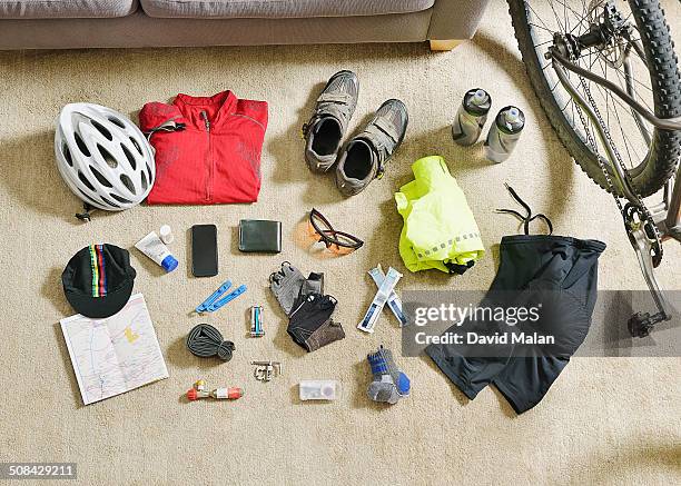 cycling gear spread out on a lounge floor - bike accessories bildbanksfoton och bilder