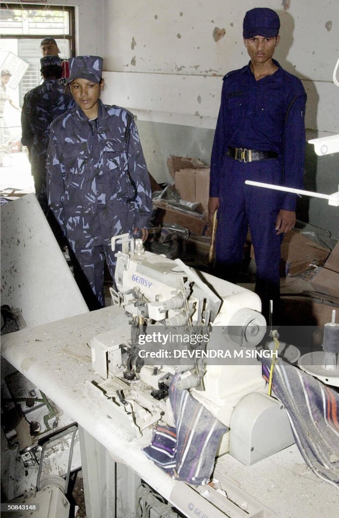Nepalese police officers inspect a bomb