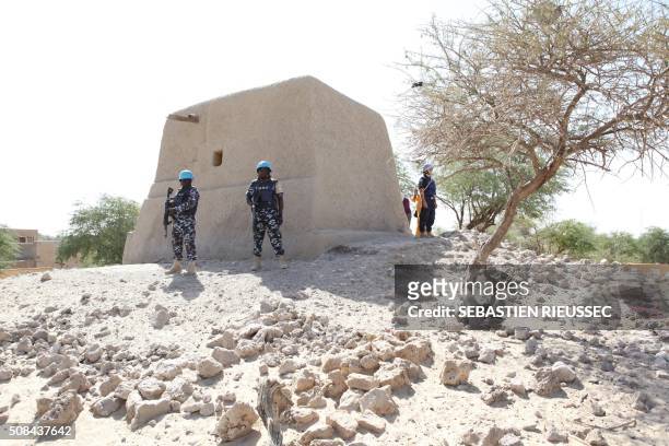 Peacekeepers stand next to the mausoleum of Alpha Moya on February 4, 2016 in Timbuktu. - The mausoleum was one among the 16 mausoleums destructed by...