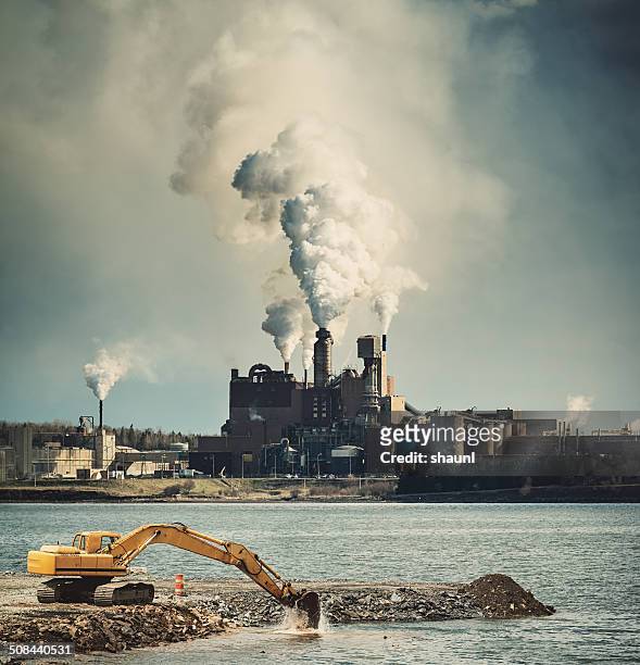 the drone of industry - smoke stack stock pictures, royalty-free photos & images