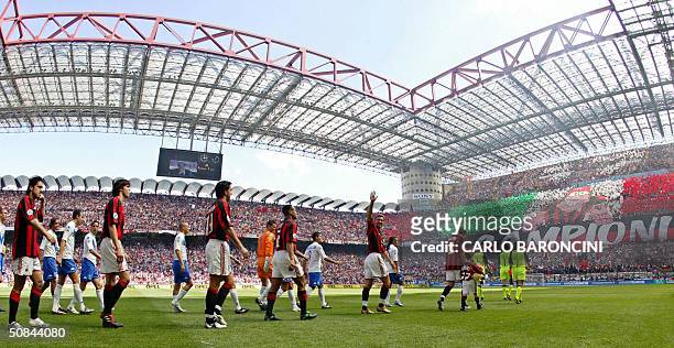 Milan's and Brescia's players walk onto the field, prior their Italian Serie A football match at San Siro stadium in Milan, 16 May 2004. For the...