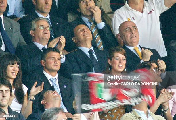 Italian Prime Minister and AC Milan's president Silvio Berlusconi watches his team playing against Brescia during their Italian Serie A football...