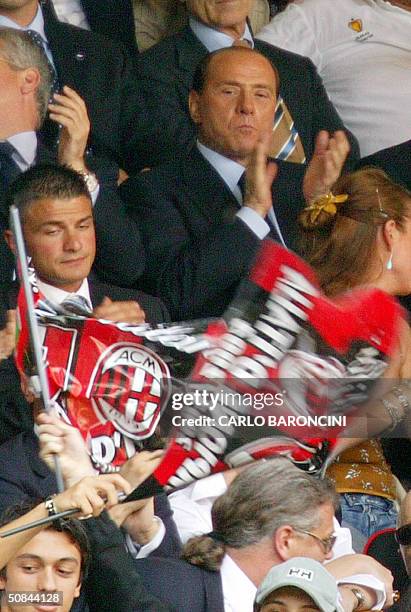 Italian Prime Minister and AC Milan president Silvio Berlusconi watches his team play against Brescia during their Italian Serie A football match at...