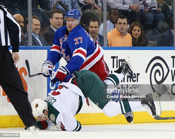 Ryan McDonagh of the New York Rangers checks Charlie Coyle of the Minnesota Wild during the first period at Madison Square Garden on February 4, 2016...