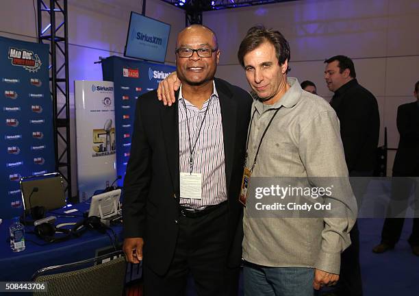 Former NFL player and head coach Mike Singletary, left, visits SiriusXM radio host Chris Russo, aka Mad Dog, at the SiriusXM set at Super Bowl 50...