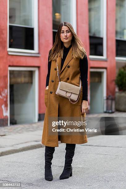 Fashion blogger Julia Haghjoo wearing Sam Edelman boots, Chloe bag, J Brand jeans, vest and top Zara during the Copenhagen Fashion Week Autumn/Winter...