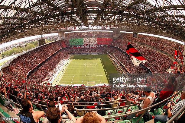 Fans enjoy the atmosphere in the stadium during the Serie A match between AC Milan and Brescia at the Stadio Giuseppe Meazza on May 16, 2004 in...