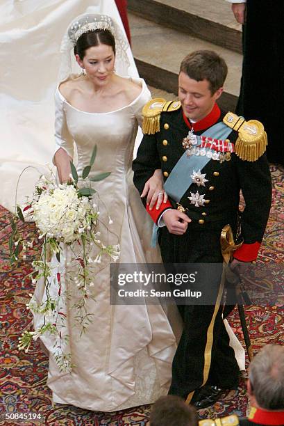 Crown Prince Frederik and Princess Mary of Denmark turn to walk up the isle of Copenhagen Cathedral after their wedding ceremony on May 14, 2004 in...