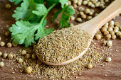 Coriander powder, Aromatic ingredients on rustic wooden table