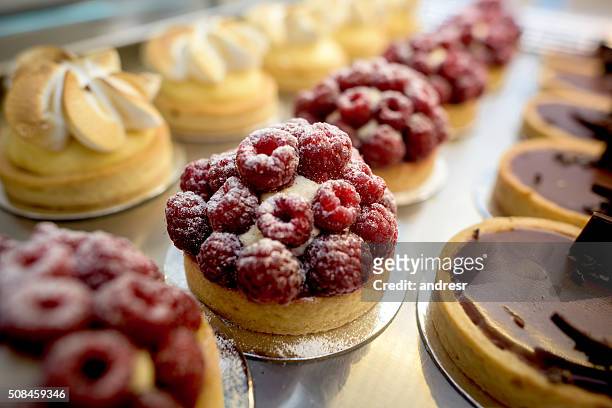 window of desserts at a pastry shop - food and drink industry stock pictures, royalty-free photos & images
