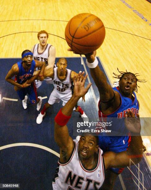 Ben Wallace of the Detroit Pistons and Rodney Rogers of the New Jersey Nets go for a rebound in Game six of the Eastern Conference Semifinals of the...