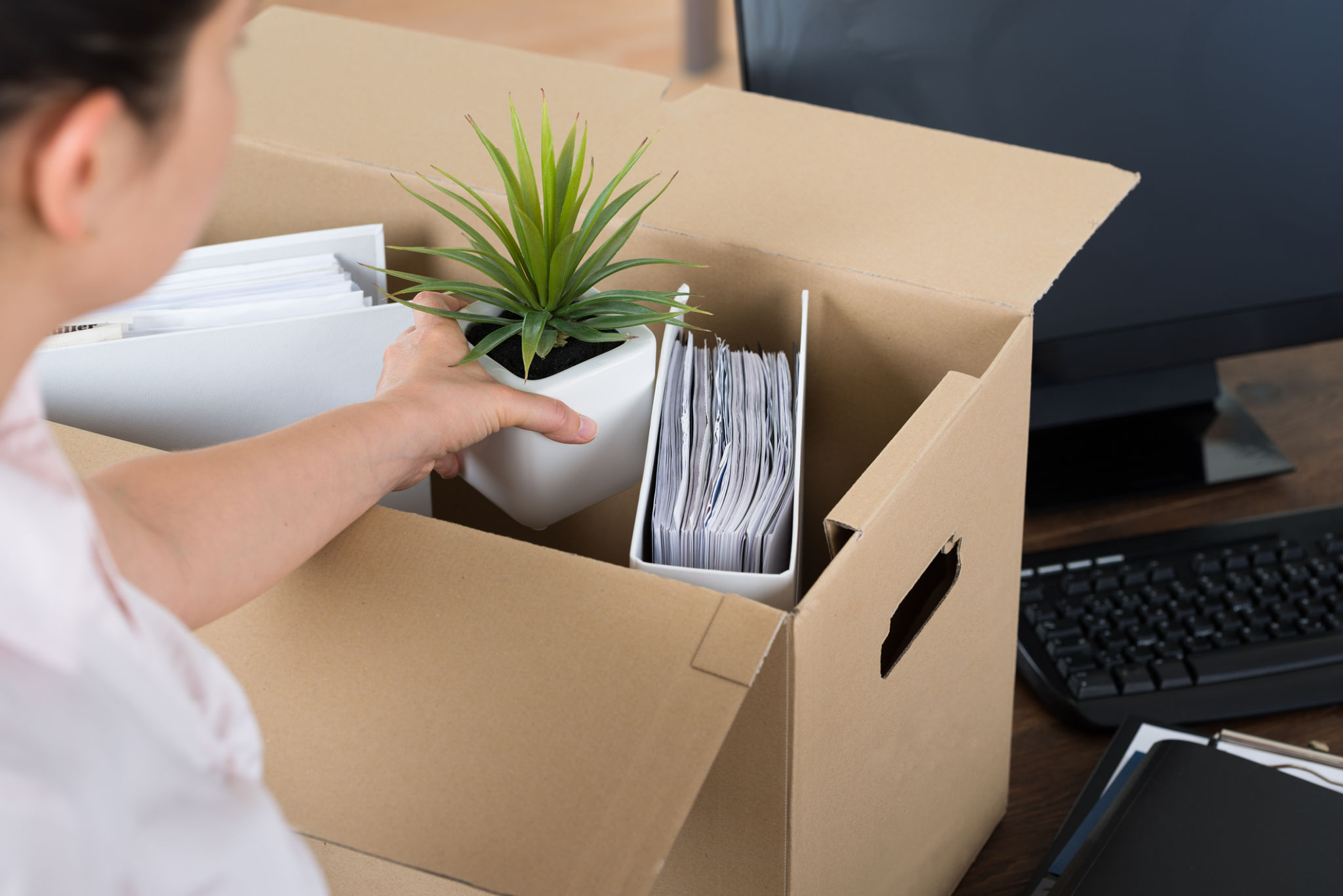 Businesswoman Packing Belongings In Cardboard Box Businesswoman Packing Belongings In Cardboard Box
