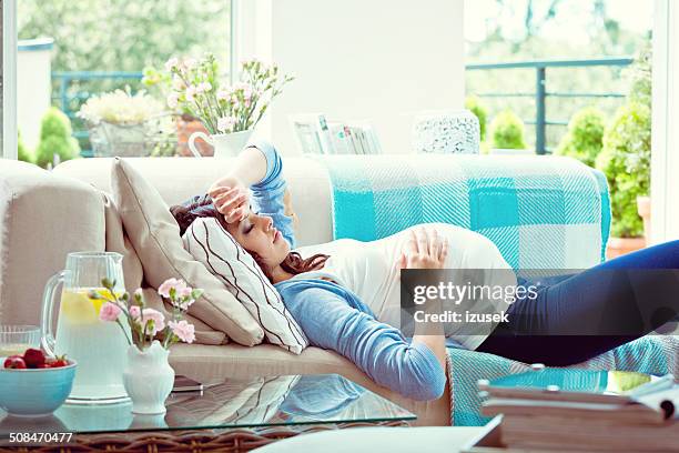 pregnant woman resting - girly pregnant stock pictures, royalty-free photos & images