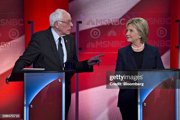 Democratic presidential candidates Senator Bernie Sanders, an independent from Vermont, left, talks to Hillary Clinton, former Secretary of State,...