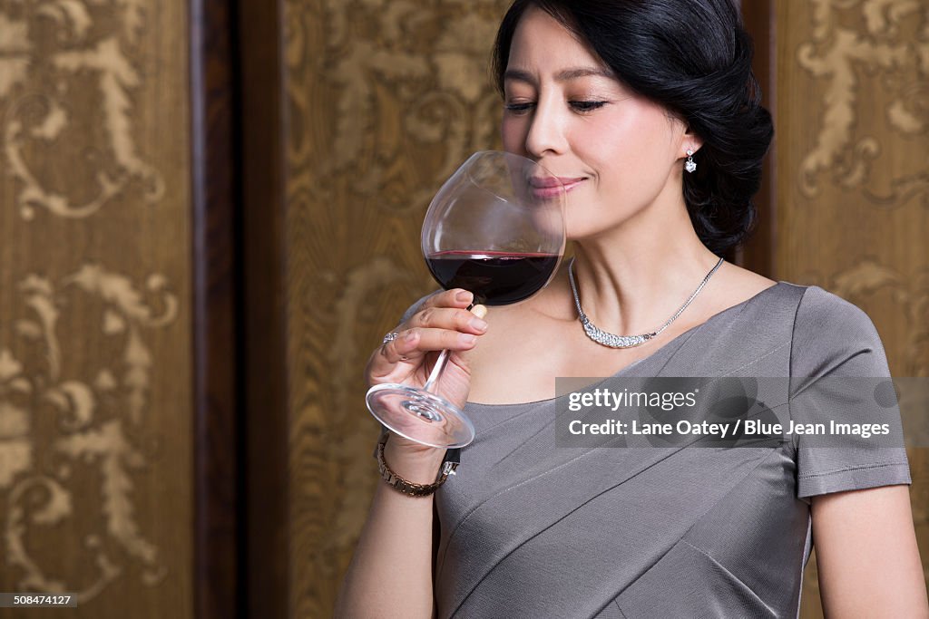 Elegant woman with red wine