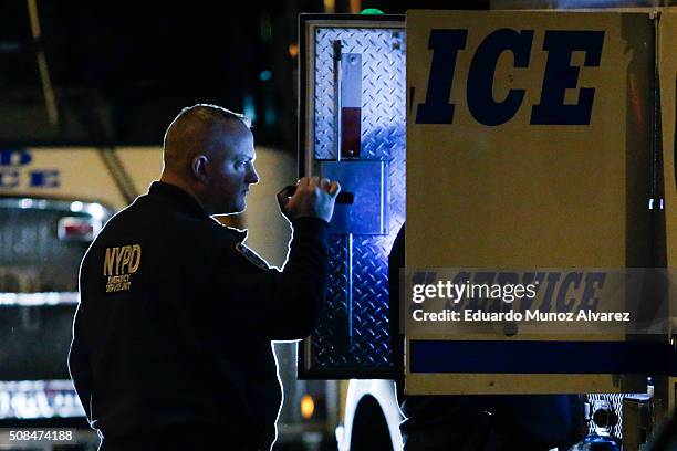 New York Police Officer checks his truck after a shooting on February 4, 2016 in the Bronx in New York City. Two NYPD officers were shot on Thursday...