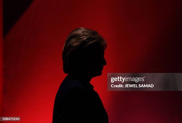 Democratic presidential candidate Hillary Clinton leaves the stage during a break as she participates in the MSNBC Democratic Candidates Debate with...