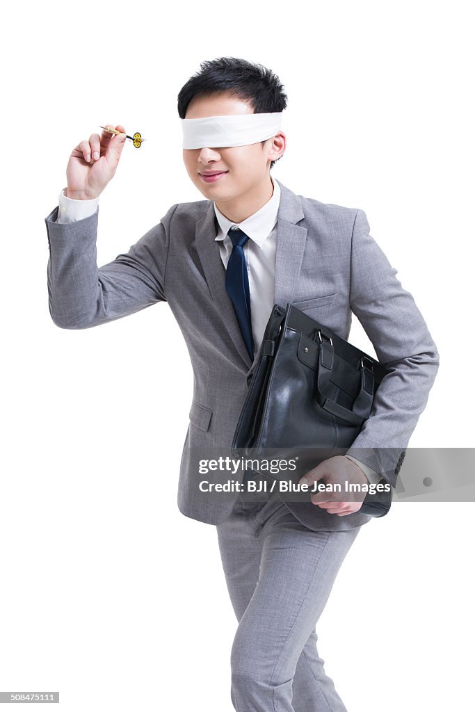 Blindfolded businessman with dart