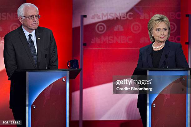 Democratic presidential candidates Hillary Clinton, former Secretary of State, right, and Senator Bernie Sanders, an independent from Vermont, listen...