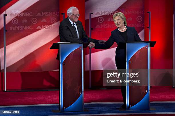 Democratic presidential candidates Hillary Clinton, former Secretary of State, right, and Senator Bernie Sanders, an independent from Vermont, shake...