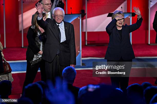 Democratic presidential candidates Hillary Clinton, former Secretary of State, right, and Senator Bernie Sanders, an independent from Vermont, wave...