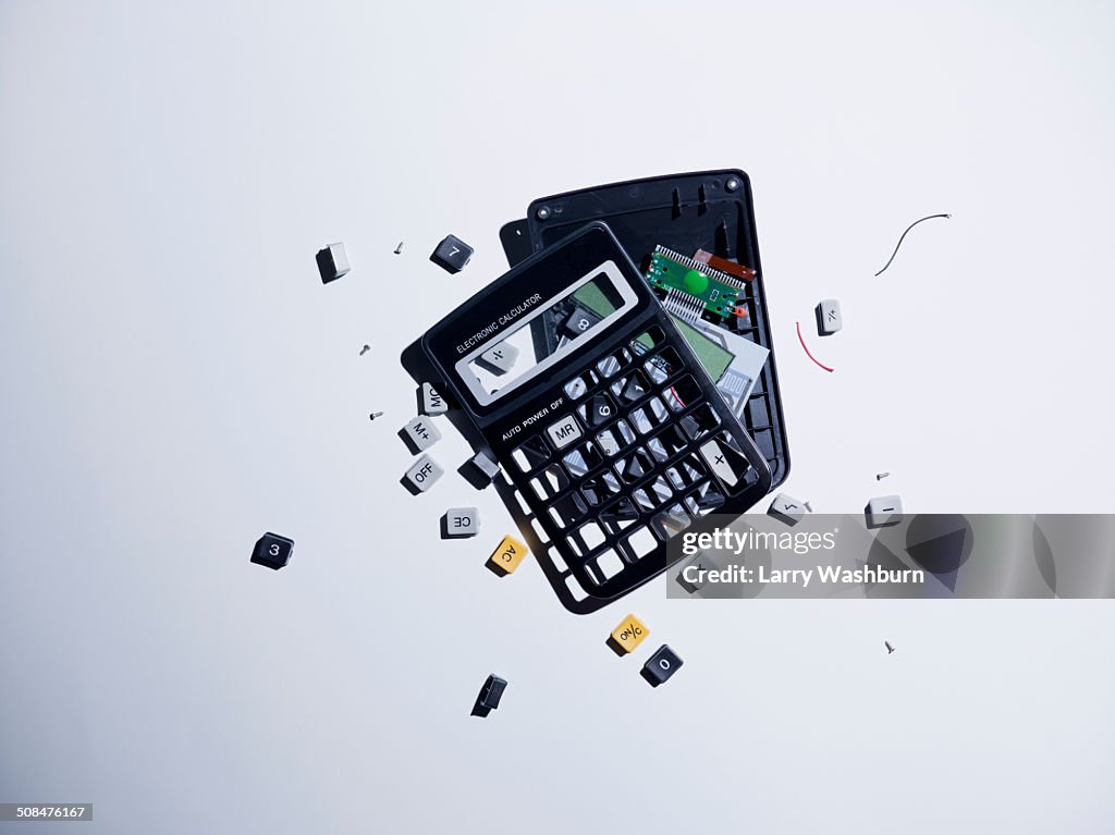 Broken calculator against gray background