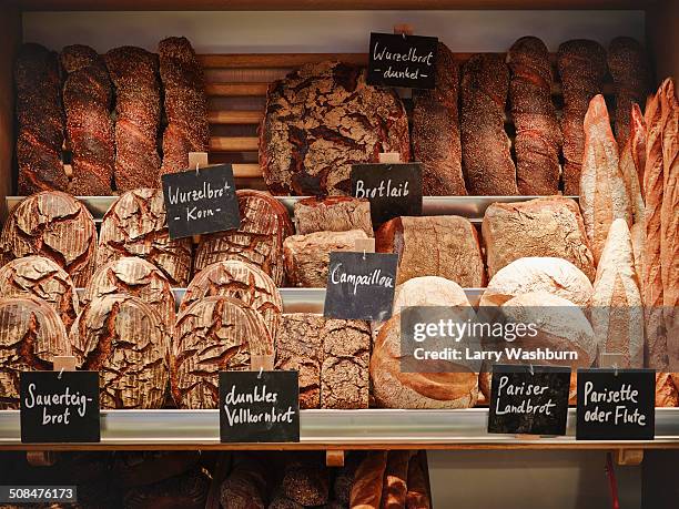 various breads displayed in shelves - bread stock-fotos und bilder