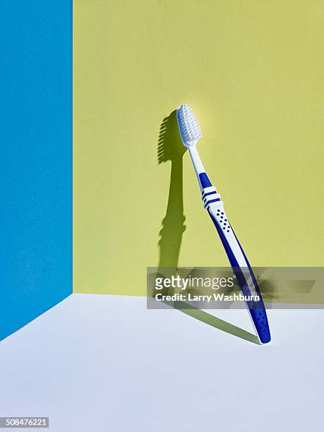 toothbrush leaning on wall - toothbrush stock-fotos und bilder
