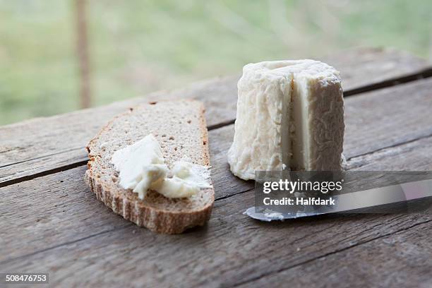 cheese with bread slice on wooden table - ziegenkäse stock-fotos und bilder