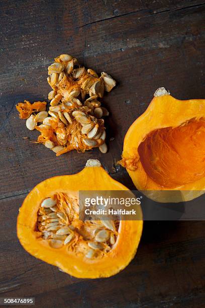 directly above shot of kuri squash halves on table - hokaido pumpkin stock pictures, royalty-free photos & images