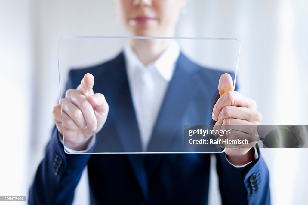 Close-up Of Businesswoman Touching On Blank Futuristic Digital Tablet