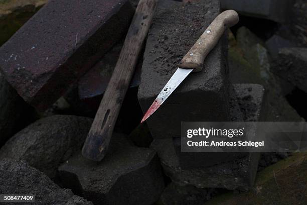 high angle view of blood stained knife on bricks - bloody knife stock pictures, royalty-free photos & images