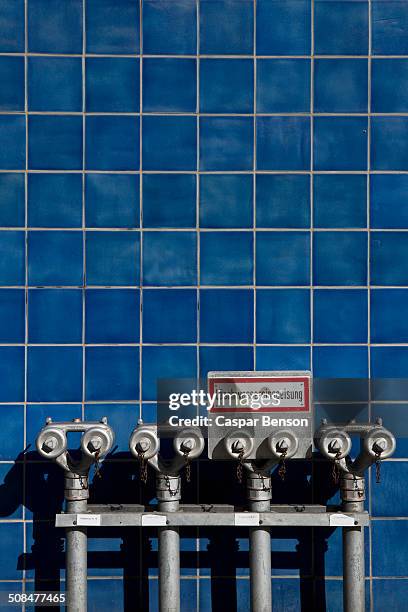 fire hydrants against blue tiled wall - blue backsplash stock pictures, royalty-free photos & images