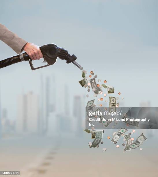 caucasian businessman pumping expensive fuel - us coin 個照片及圖片檔