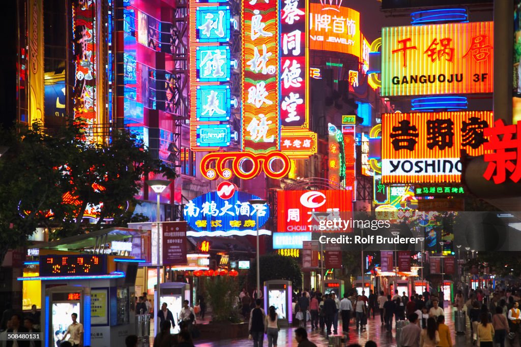 City street lit up at night, Shanghai, China